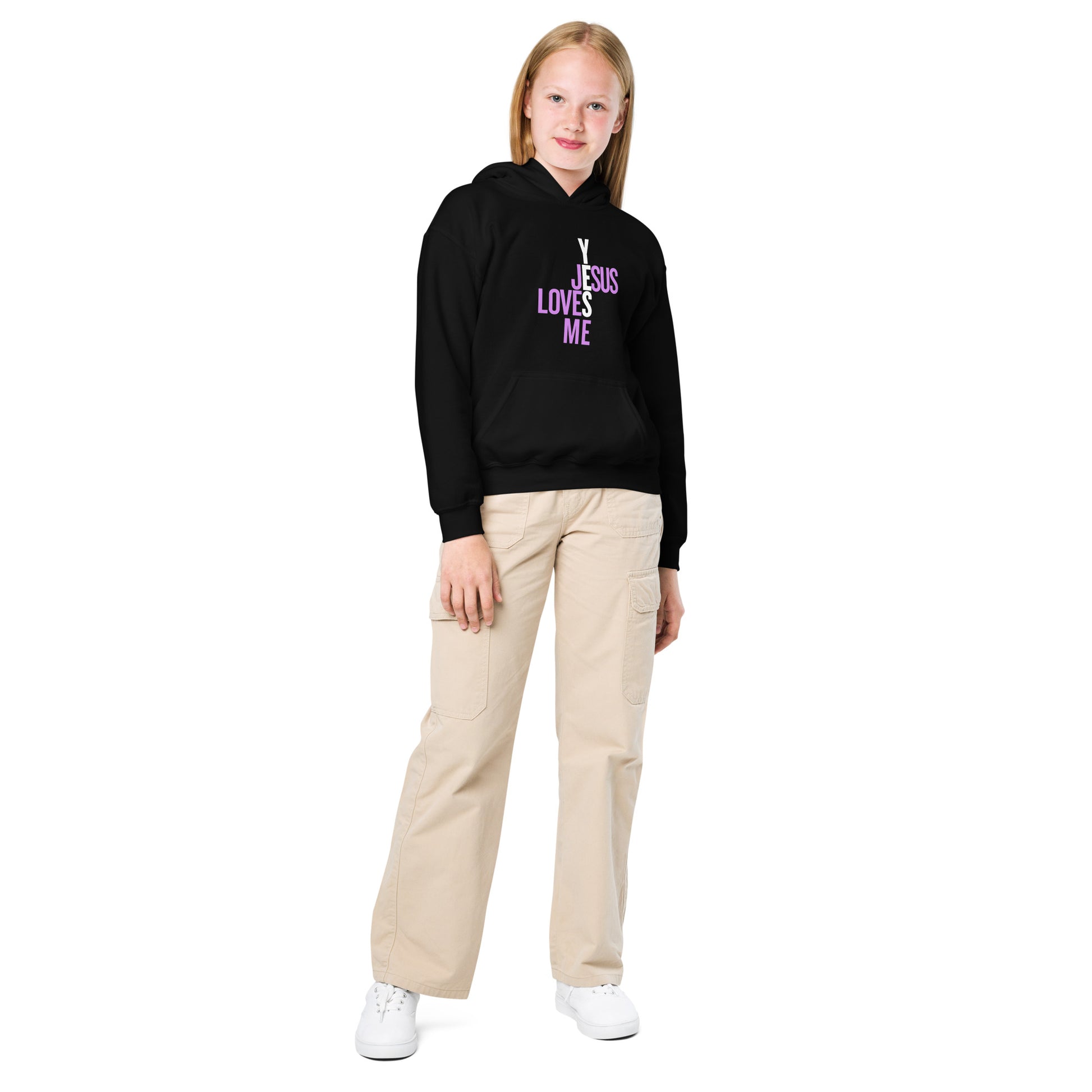 Person wearing a black hoodie with yes,  'Jesus Loves Me' text, beige pants, and white shoes on a white background
